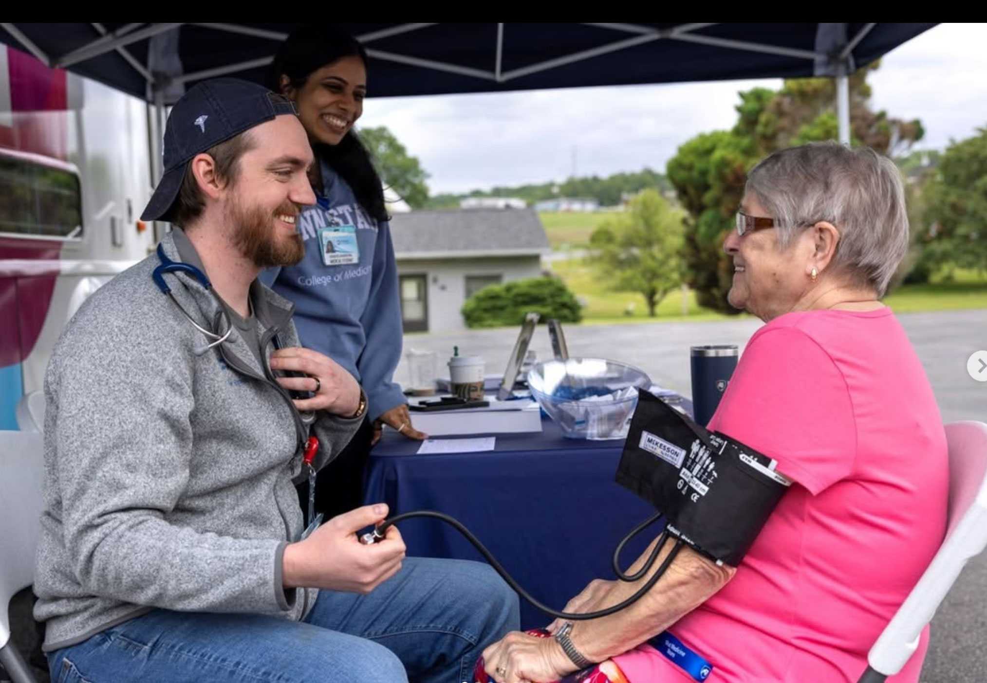 Barnett talking to a patient at the LION Mobile, photo by Penn State College of Medicine