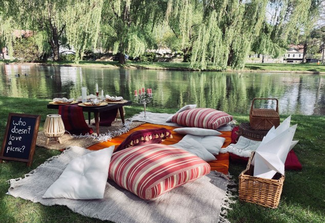 photo of a picnic setup near water in a park courtesy of Renea Nichols